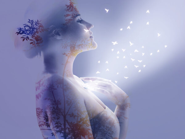 Multiple exposure of woman touching her chest and elements of nature, tree and birds.